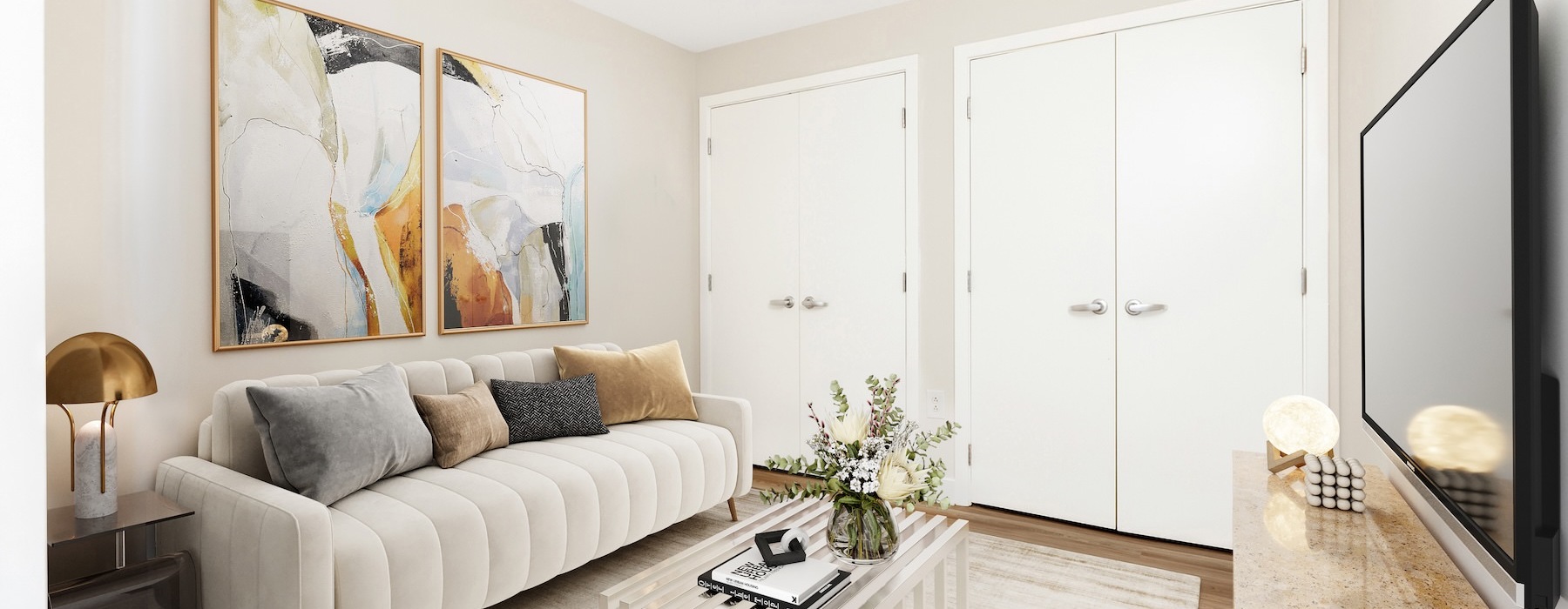 a living room with a white couch and a tv