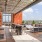a patio with tables and chairs