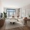 a living room with a couch, tv, tables and chairs