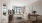a living room with a couch, tv, tables and chairs