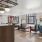 a clubroom with a table, chairs and a chandelier