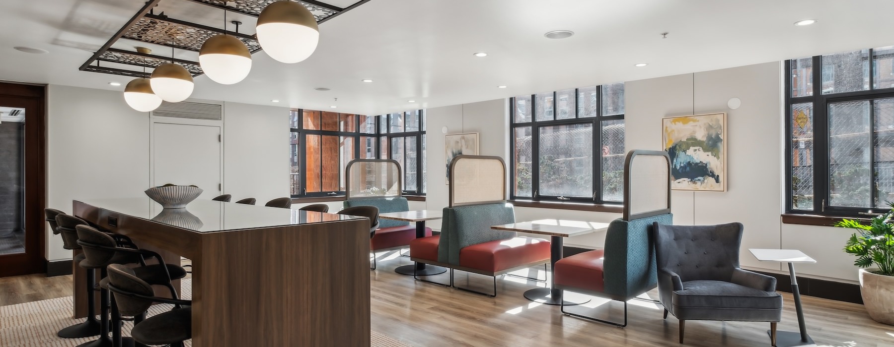 a clubroom with a table, chairs and a chandelier