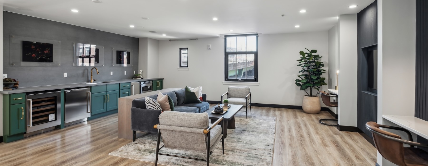 a clubroom with a couch, chairs and a table