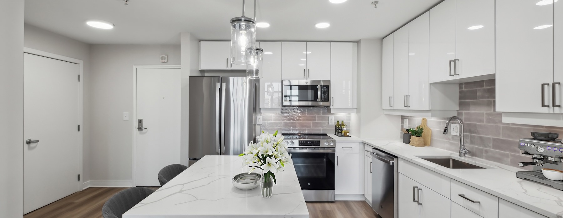 Model kitchen with white marble countertops in a 1 bedroom apartment in Washington, DC at Senate Square.