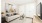a living room with a white couch and a tv