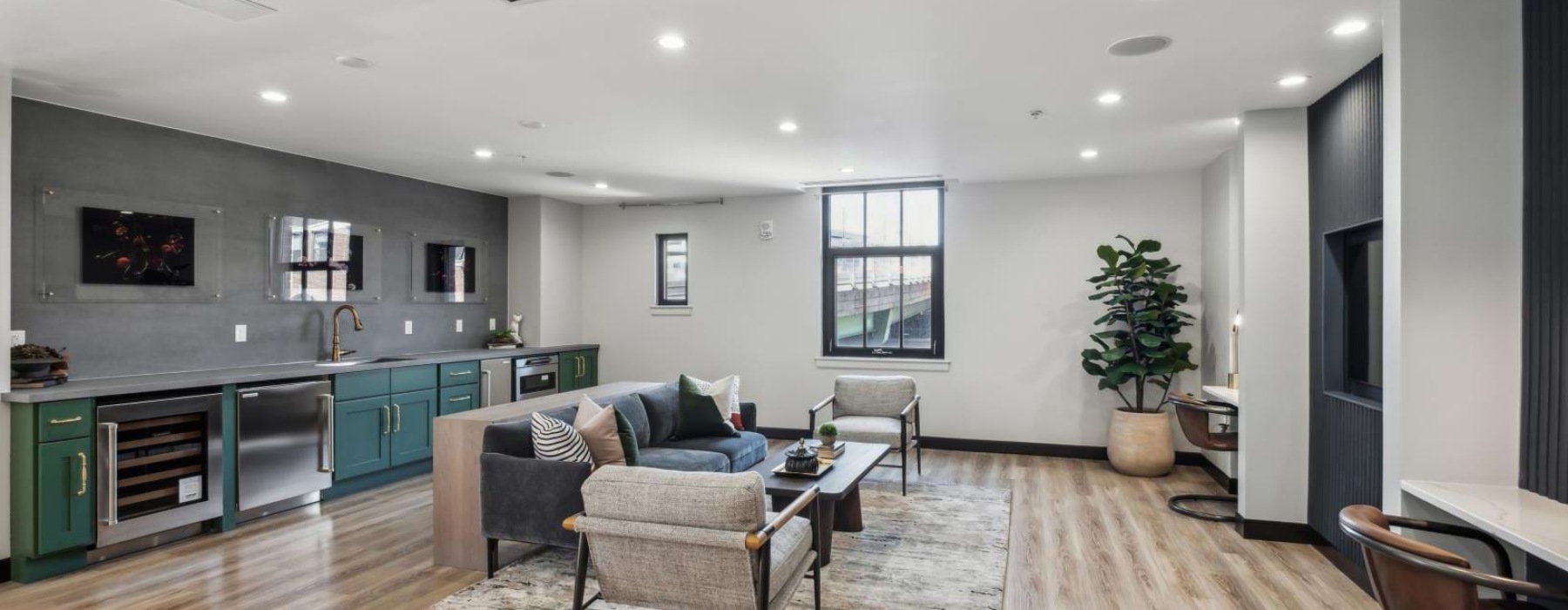 a clubroom with a couch, chairs and a table