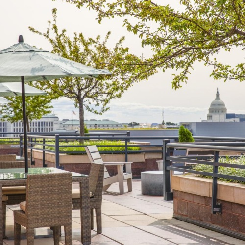 a patio with tables and chairs