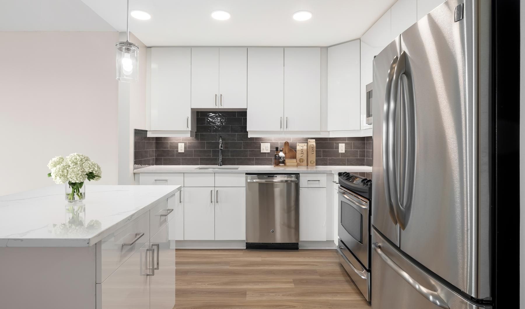a kitchen with white cabinets