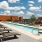 a swimming pool with chairs around it
